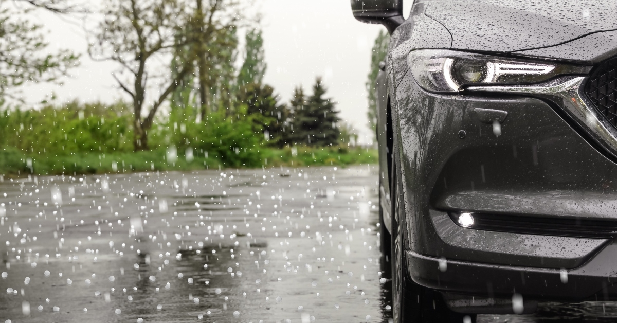 modern car parked outdoors on rainy day with hail