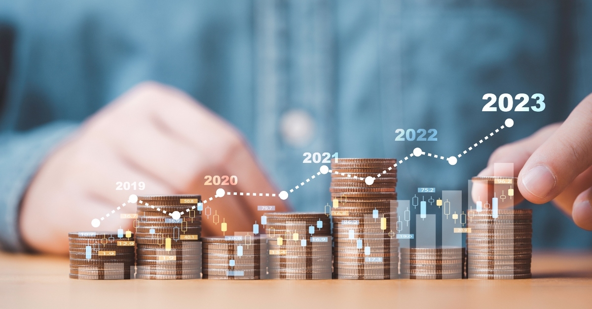 businessman stacking money coins with up arrow