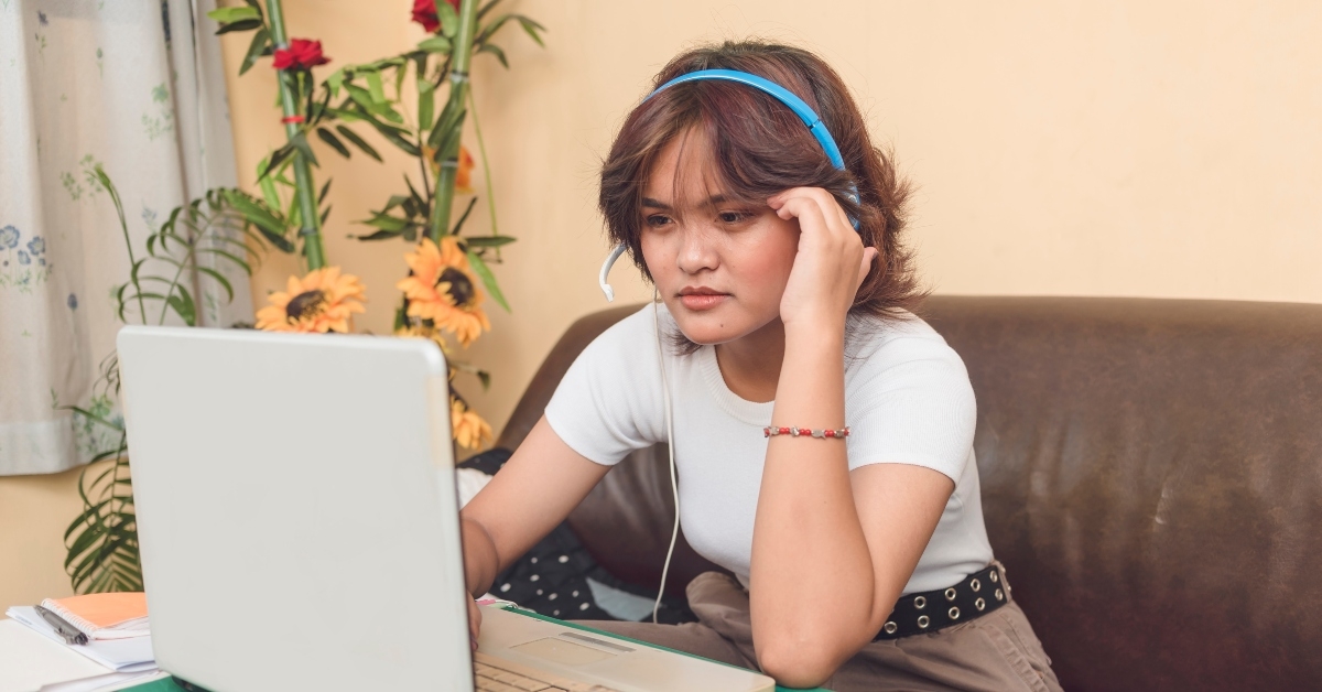 stylish online transcriber sitting on a sofa