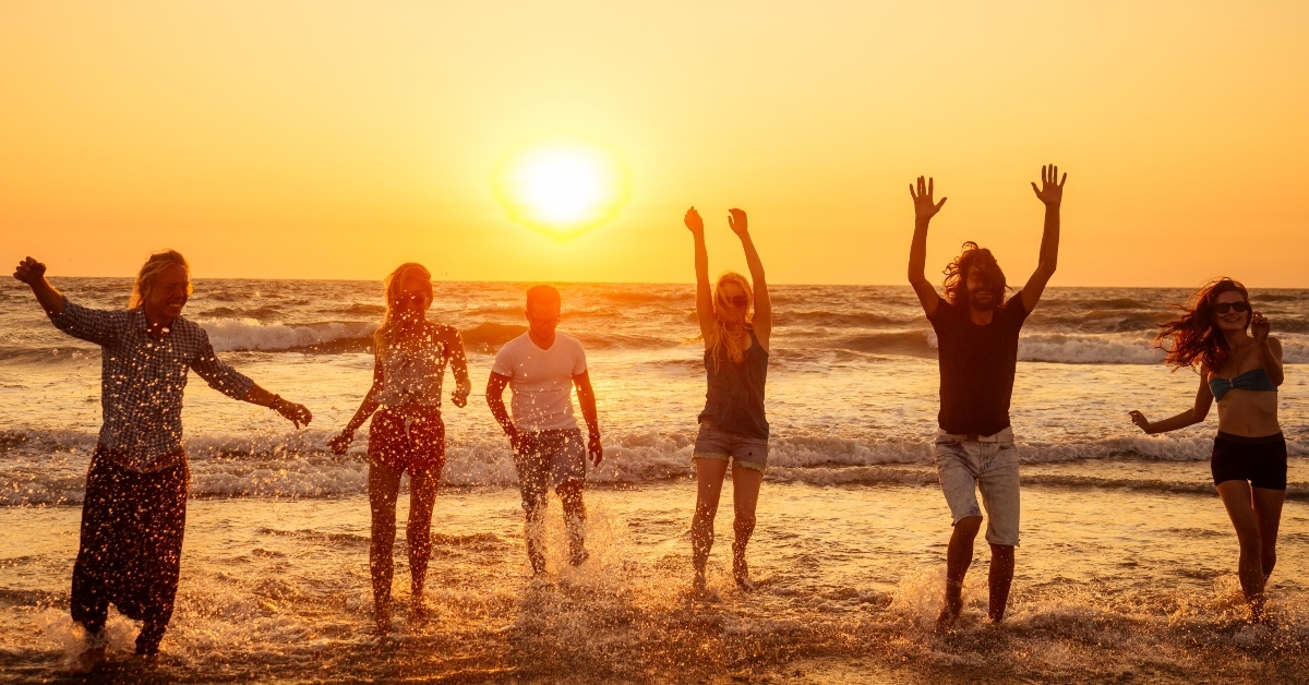 happy people running into the sun carefree