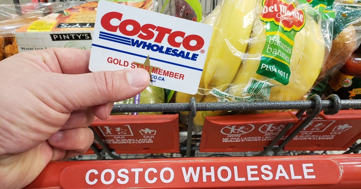 holding a costco membership card on a cart
