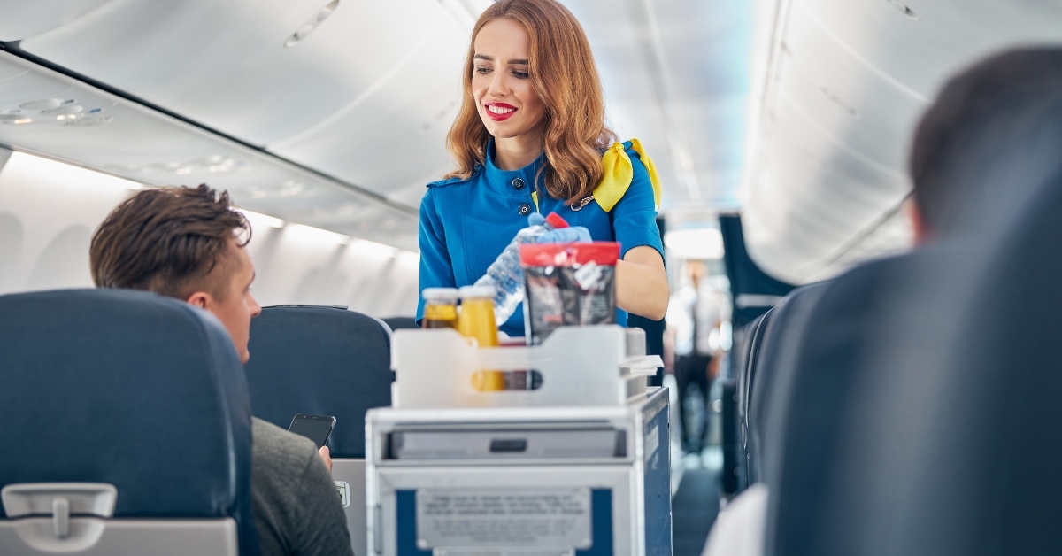 flight attendant serving food and drinks