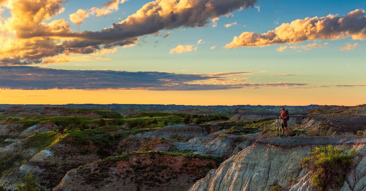 man hiking on the mountains of north dakota