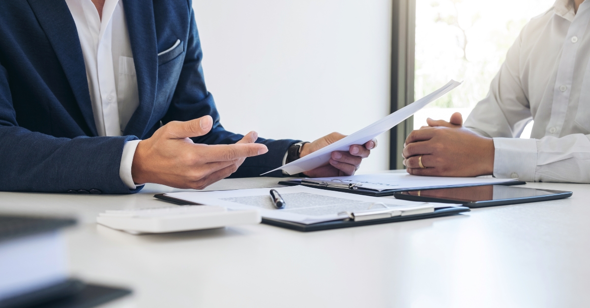 agent man presenting car insurance detail to customer