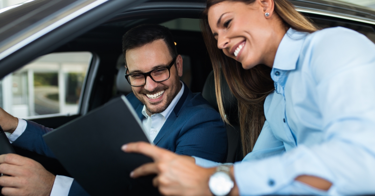 saleswoman at the dealership showroom talking with customer
