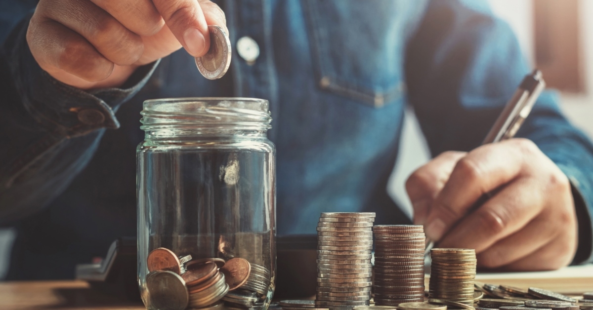 man saving pennies in a jar