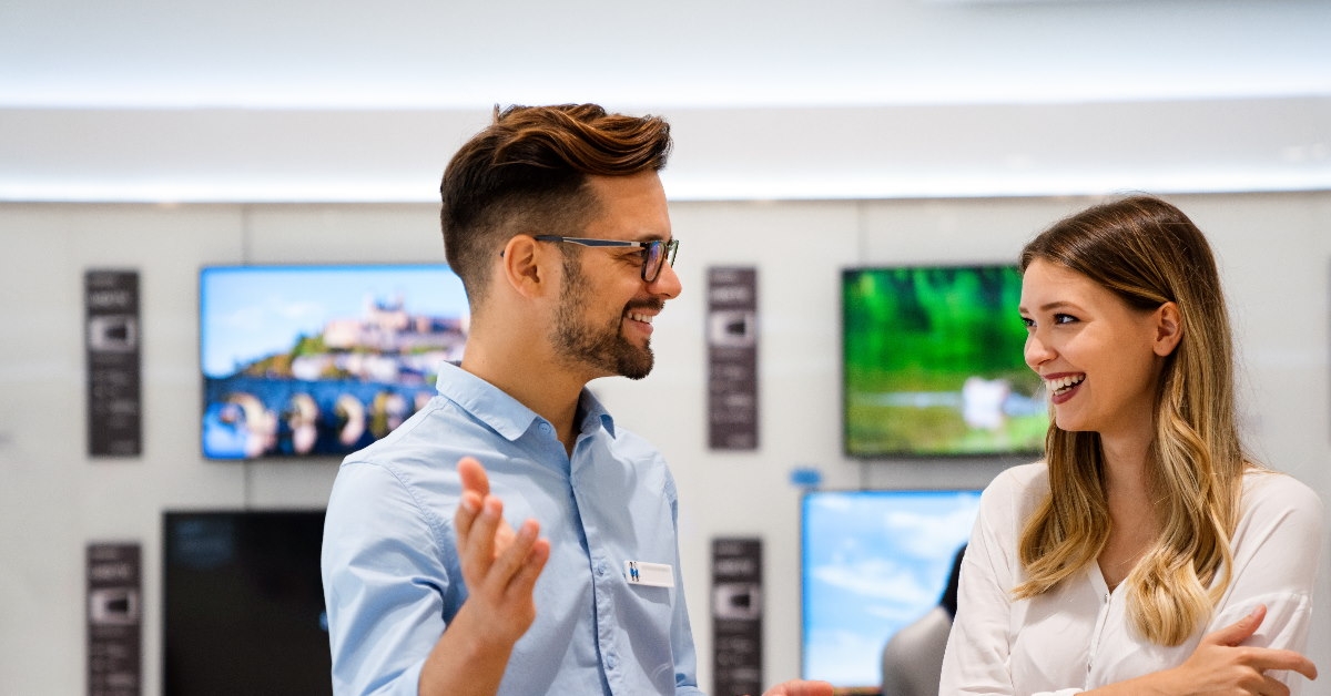 salesman at store explaining things to beautiful lady