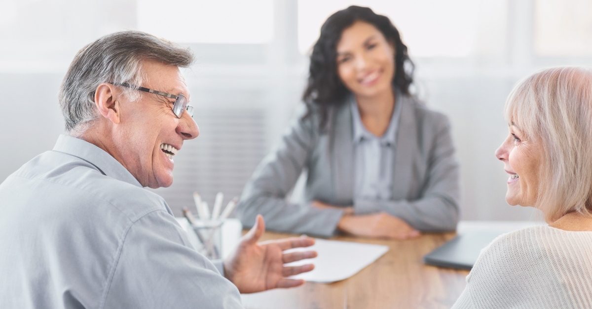 mature couple consulting with financial adviser