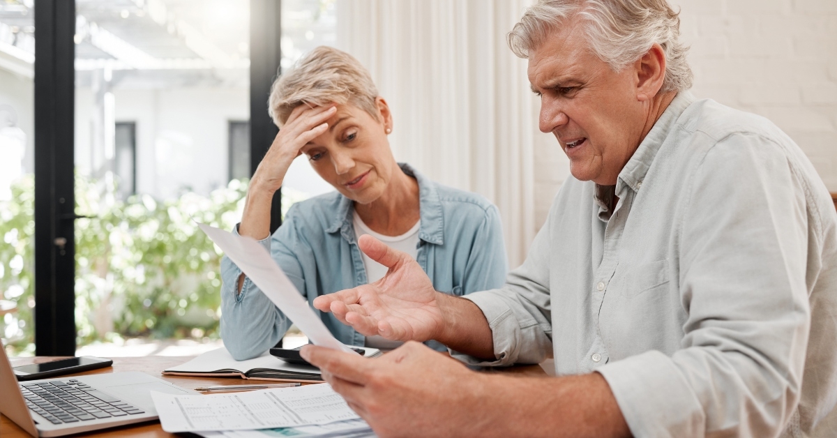 sad retired couple with debt