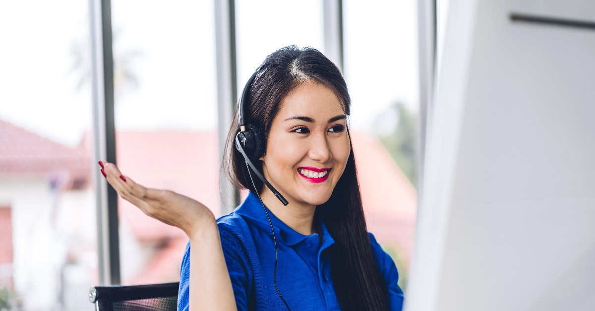 happy asian woman wearing headset working at call center