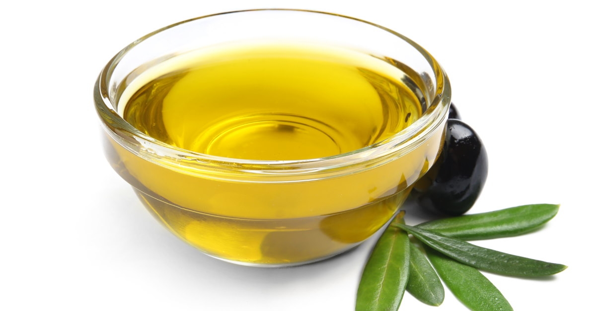 olive oil in bowl with black olives