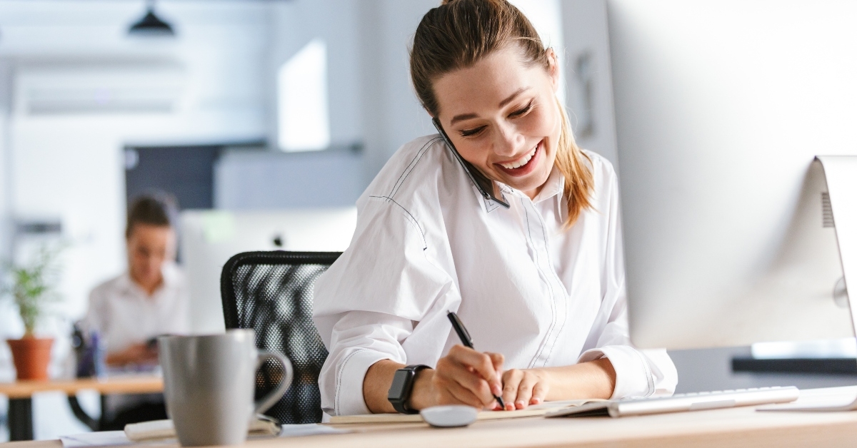 cheerful businesswoman sitting at her workplace