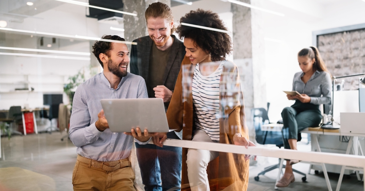 cheerful coworkers in office during company meeting