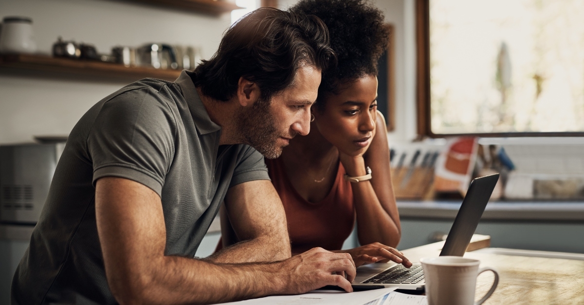 couple with a laptop doing finance paper work