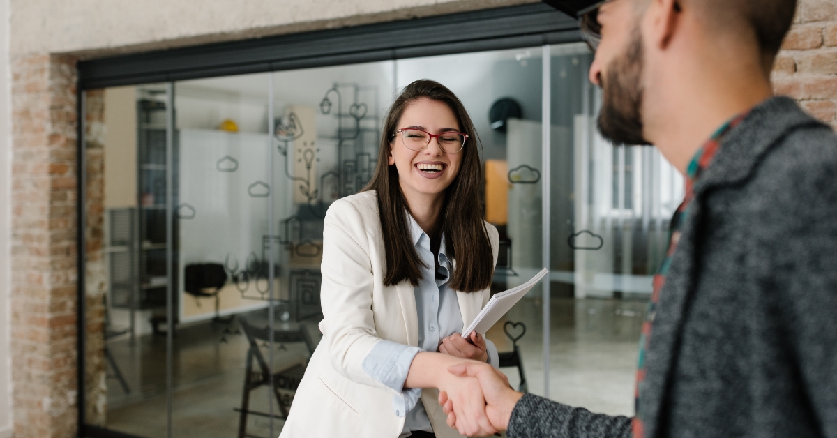 handshaking and smiling candidly at a job interview