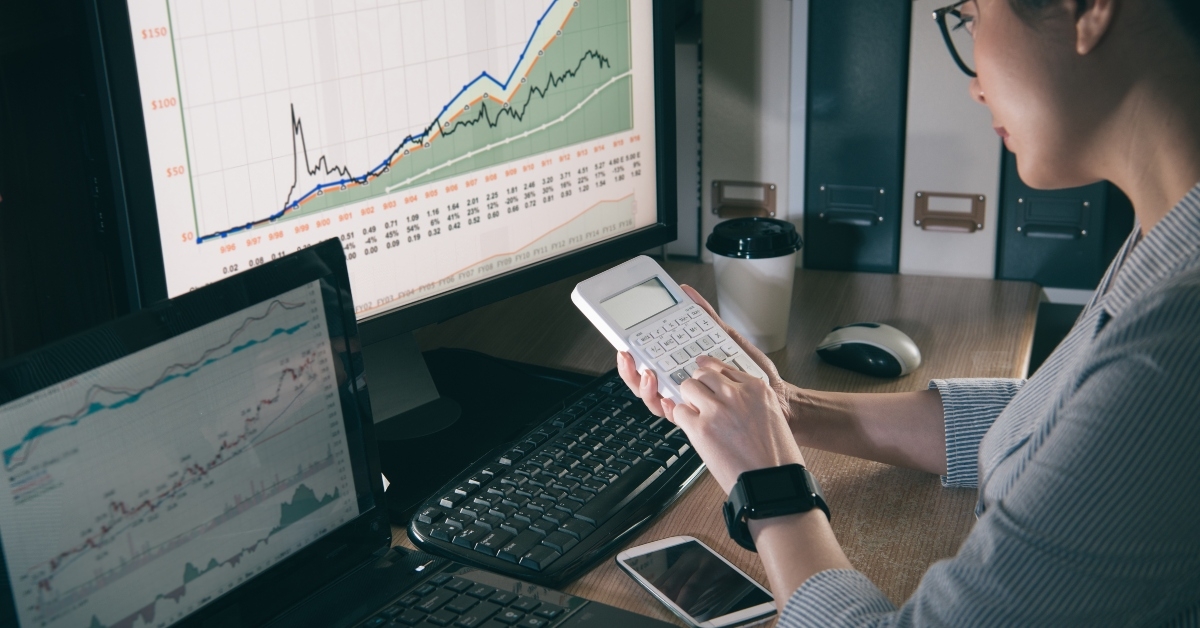 businesswoman calculating infront of computers