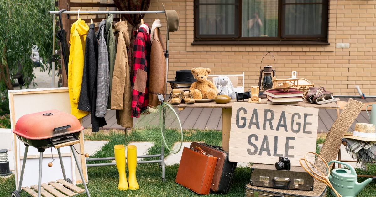 clothes and old suitcases at garage sale 