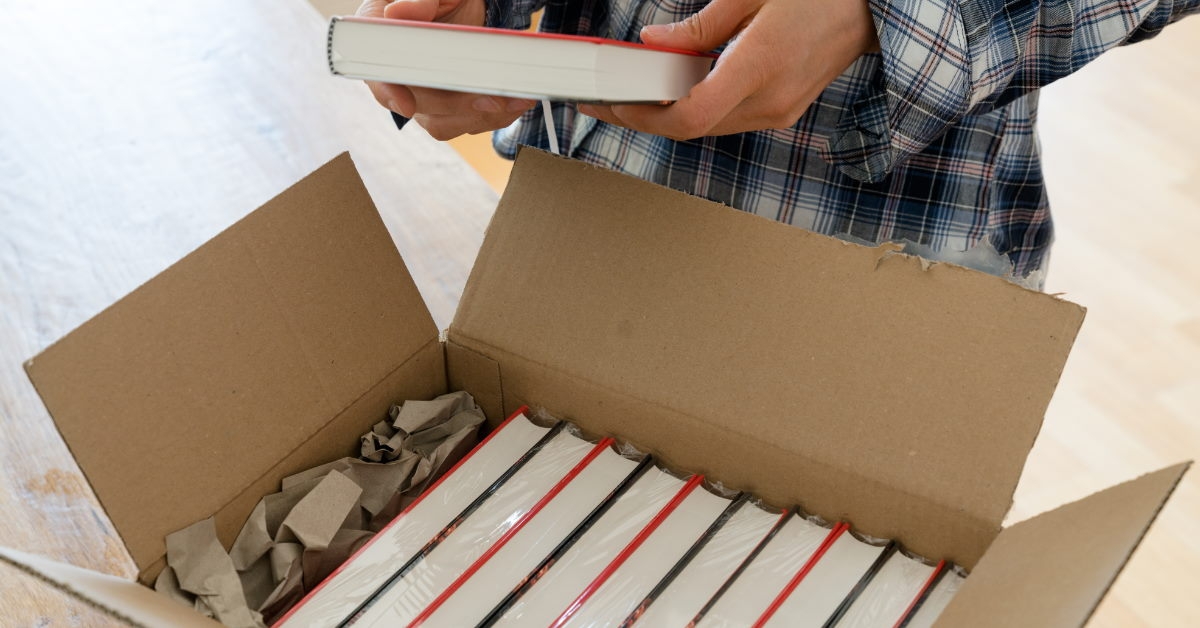 man checking new books from a package