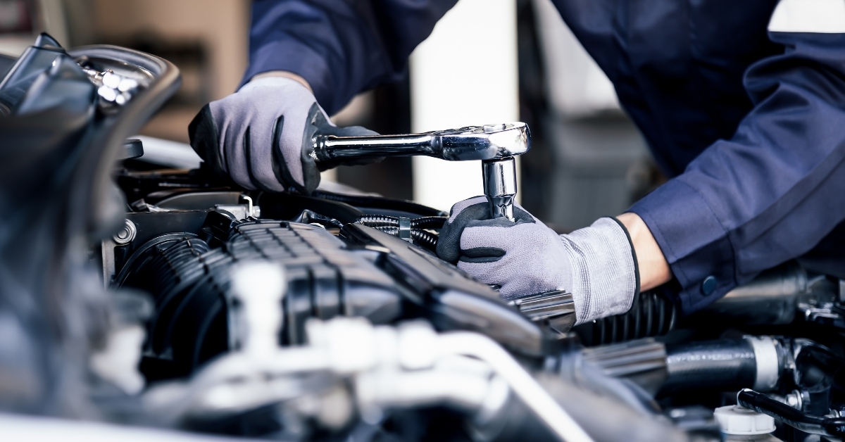 mechanic working on the engine of the car