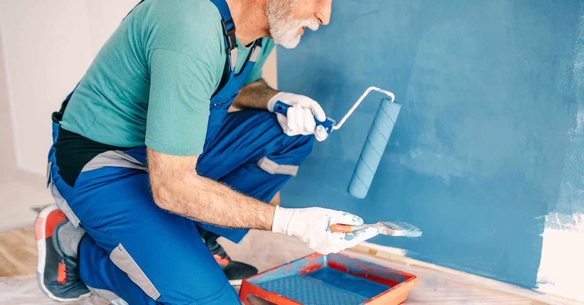 senior male painter painting a wall
