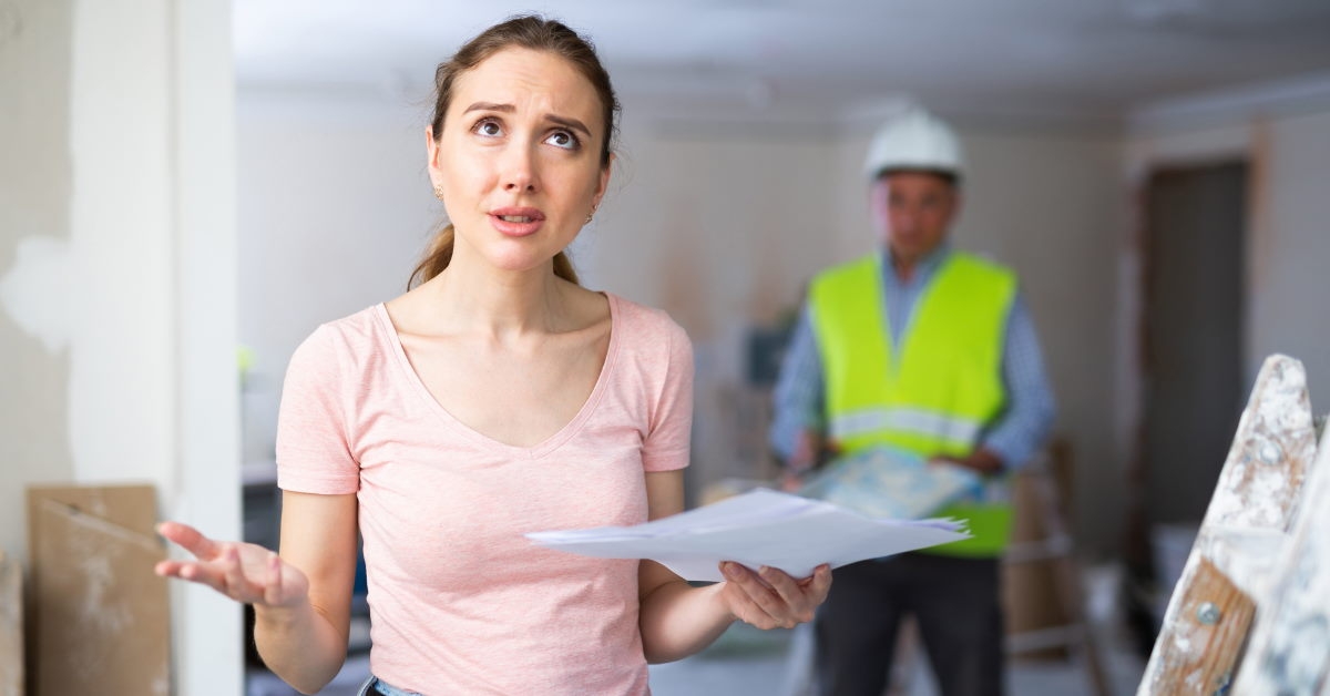 woman holding papers stressed during home renovation