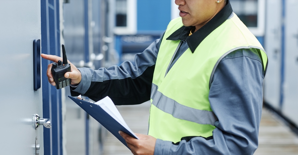 worker entering key code on storage unit