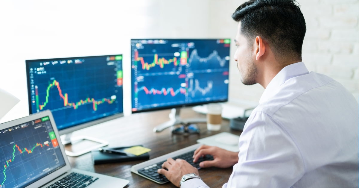 young broker sitting in office trading stocks 