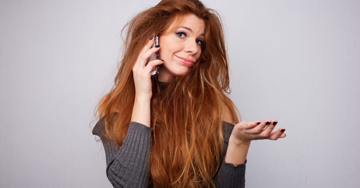 stressed woman with messy hairstyle talking on cellphone