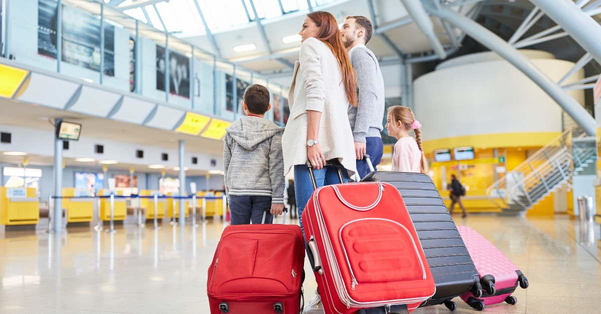 family and children with many suitcases in the airport