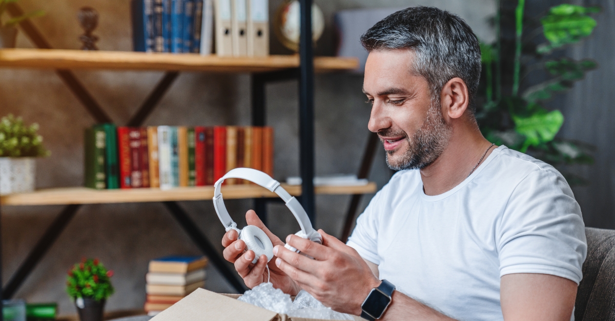 middle aged man get his delivery with heaphones 