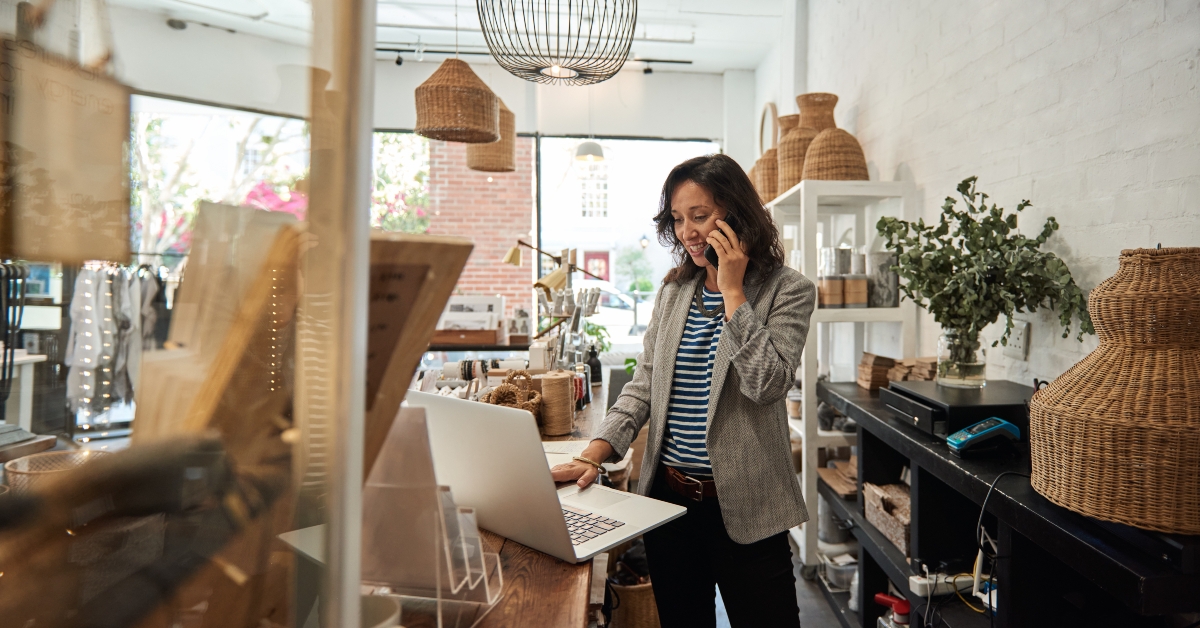 woman talking on a cellphone in her store