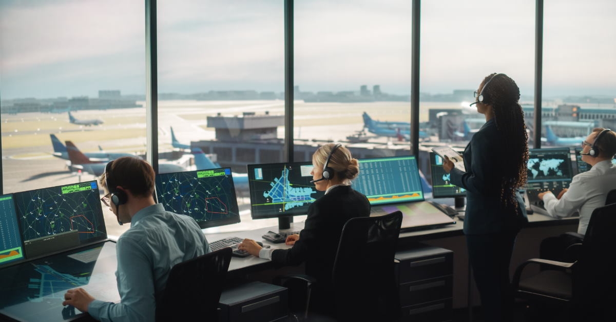 air control team working on monitors to control flights 