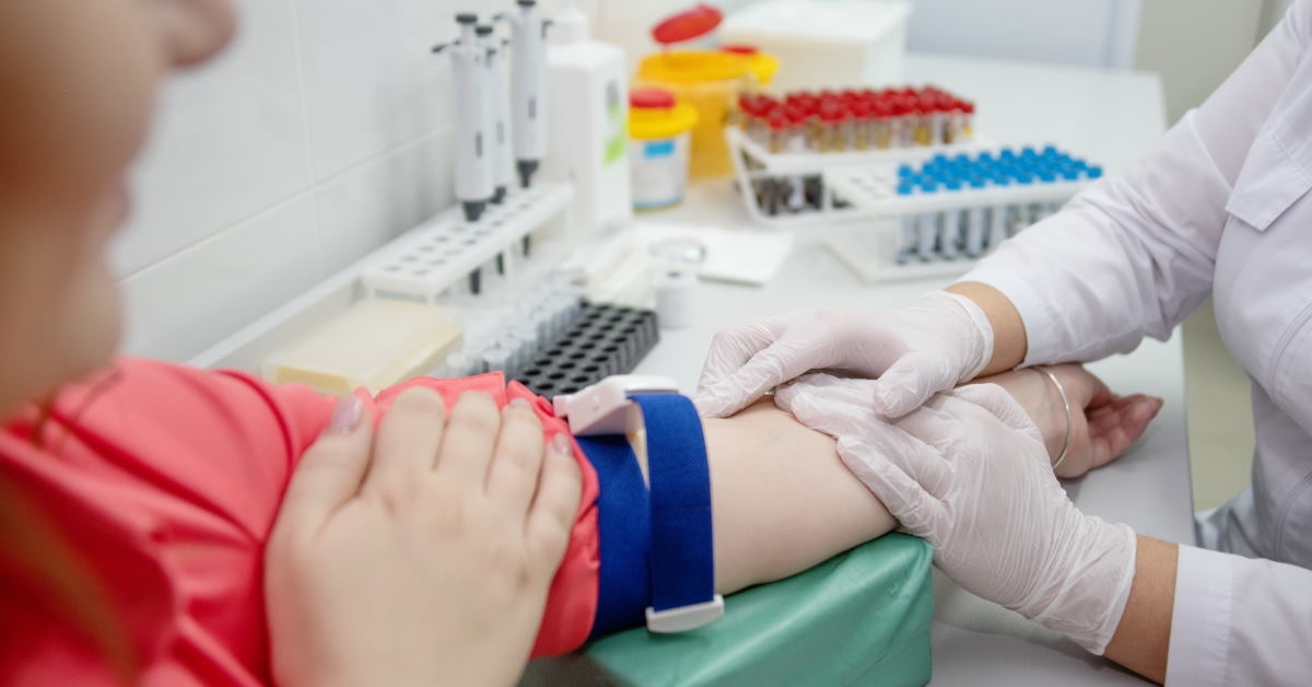 female nurse holding a womans hand for conducting blood test