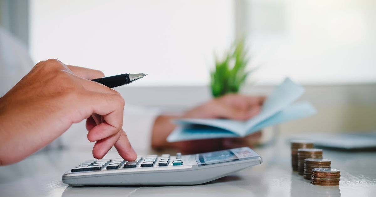 man working with calculator to calculate expenses