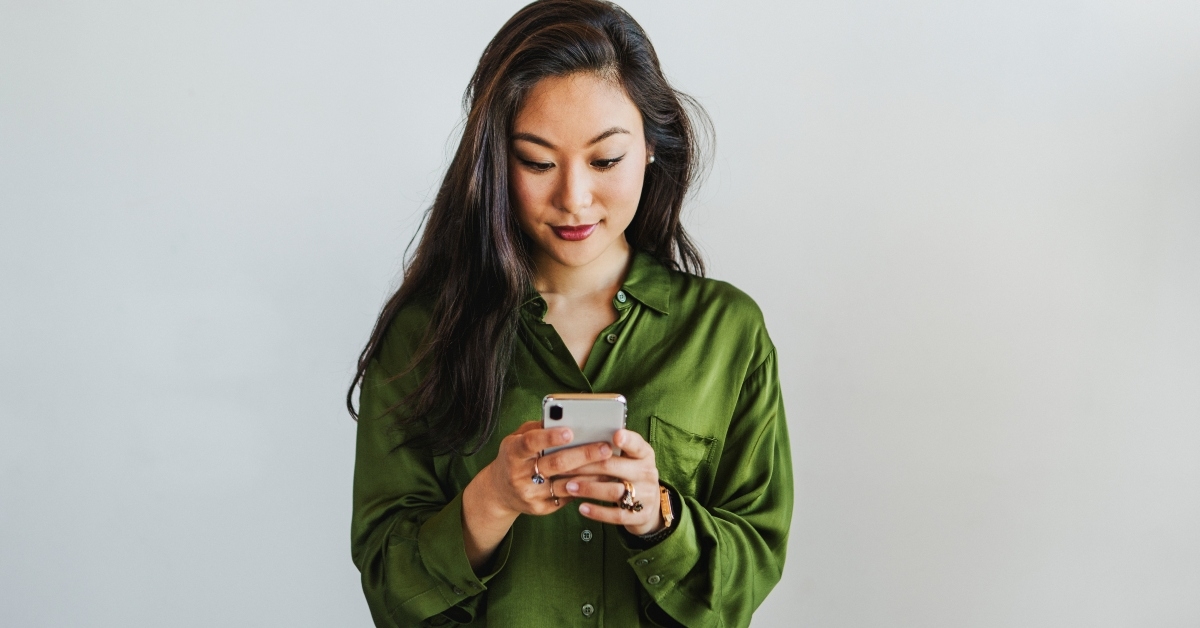 Smiling woman looking at phone