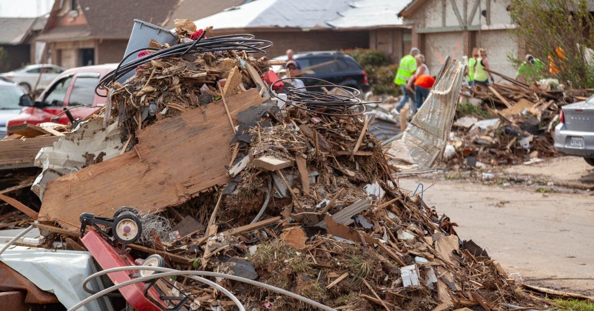 debris piled up during tornado destruction cleanup