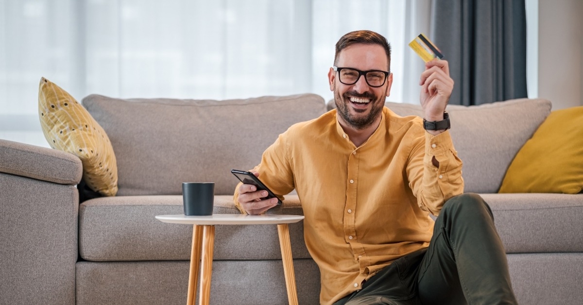 man with credit card using mobile phone
