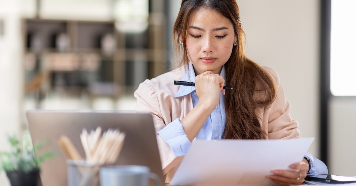 woman working with laptop thinking of professional plan