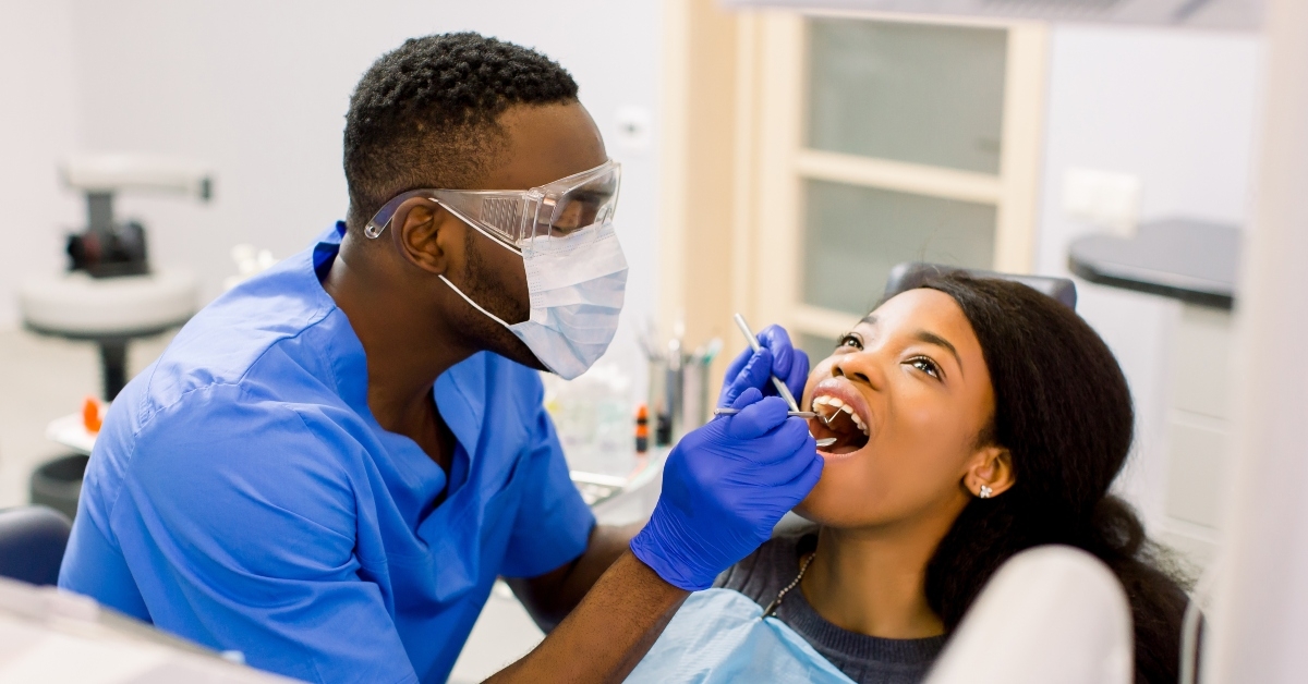 young female patient examined by male dentist