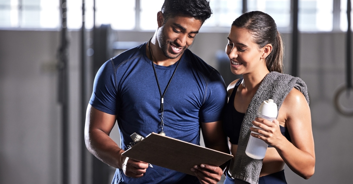 personal trainer and happy client talking