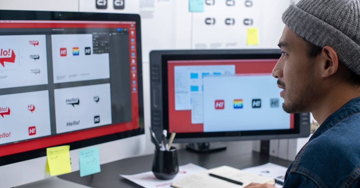 graphic designer working on computer drawing sketches logo design