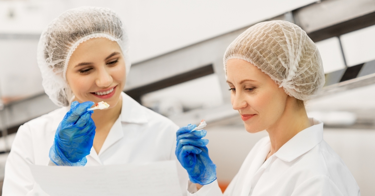 women technologists with clipboard tasting ice cream
