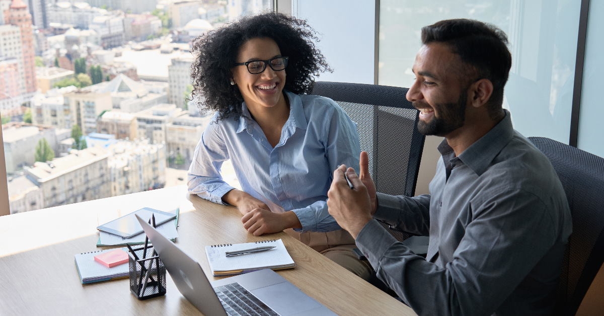 colleagues in the office chatting joyfully