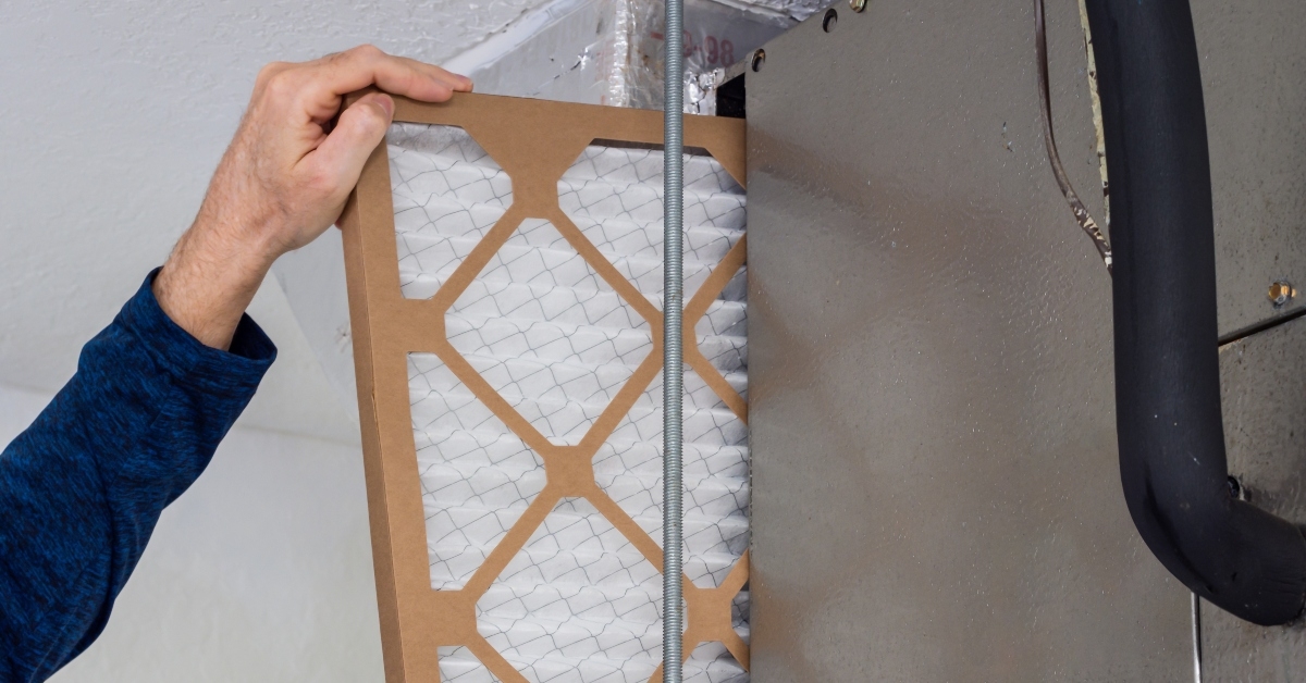 HVAC service technician changing dirty air filter