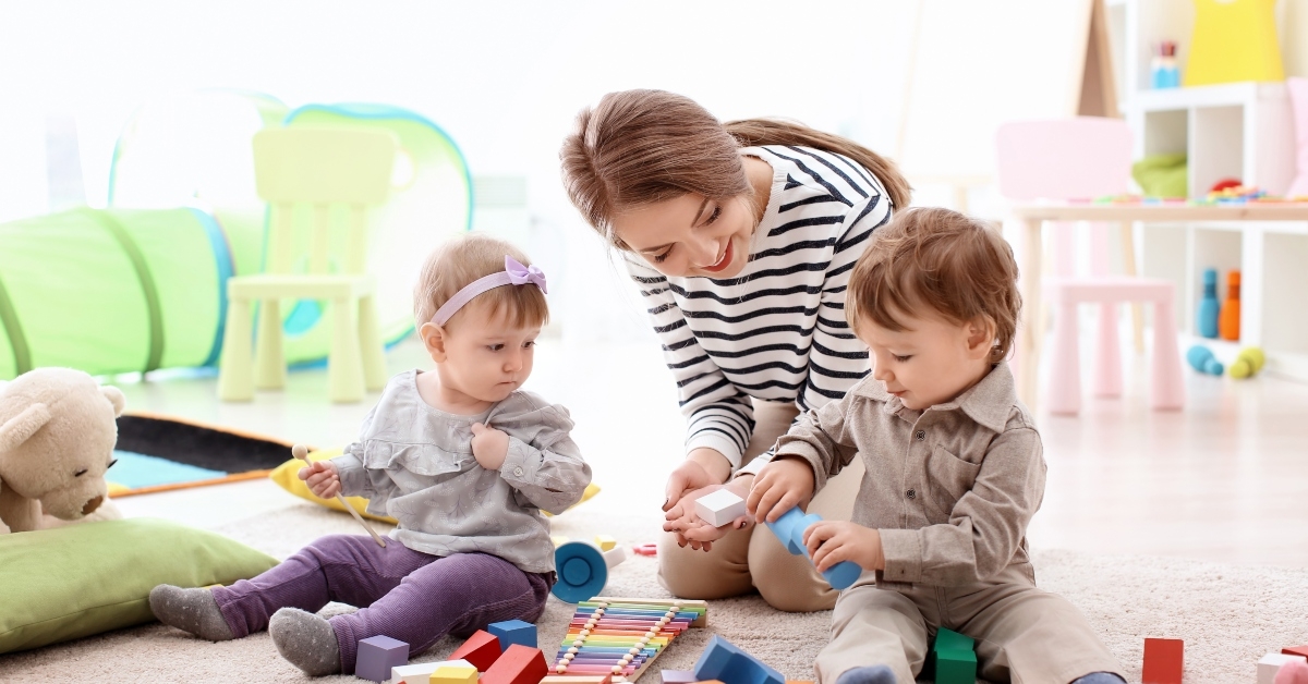 nanny playing with little children