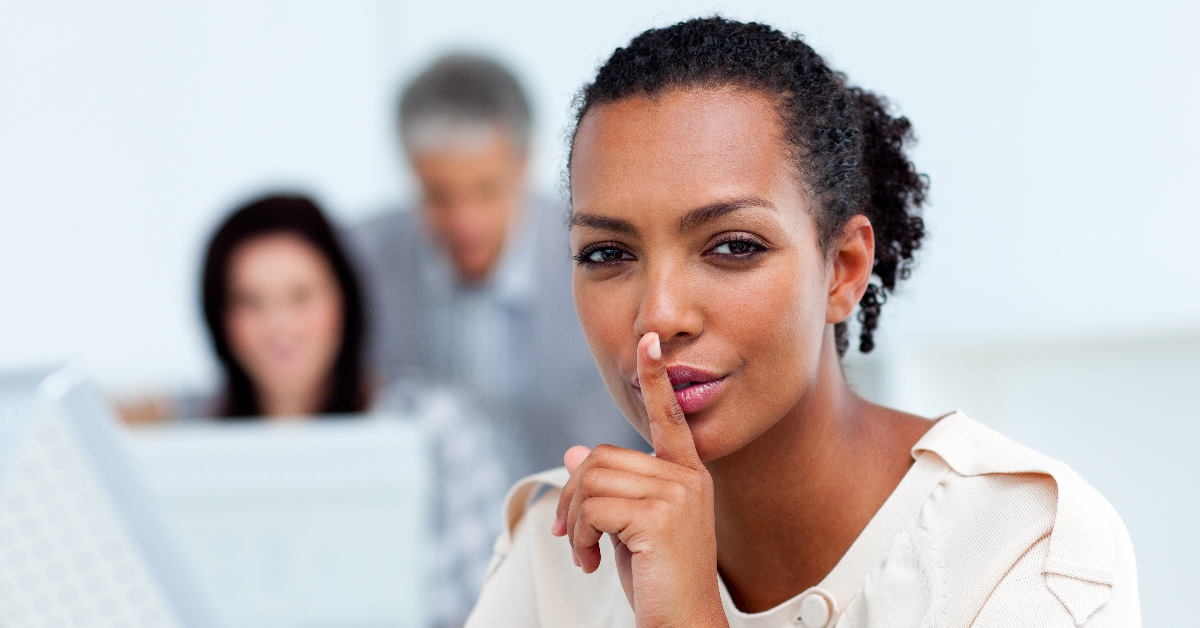 woman asking for silence by keeping fingers on her lips