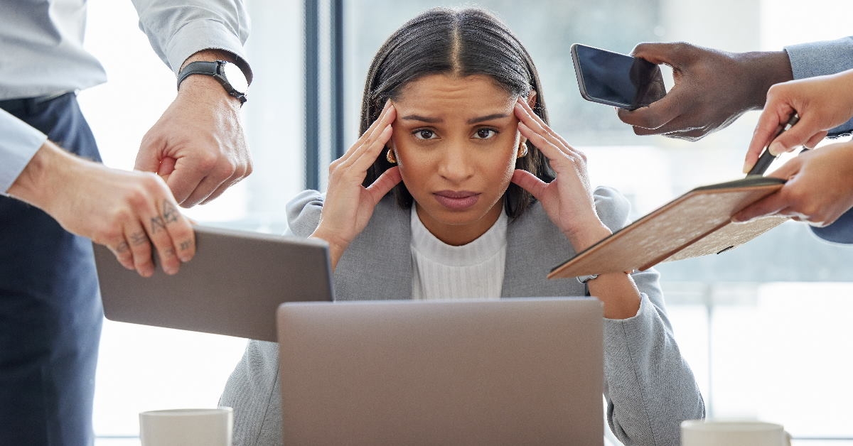 woman at work stressing because of workload by colleagues