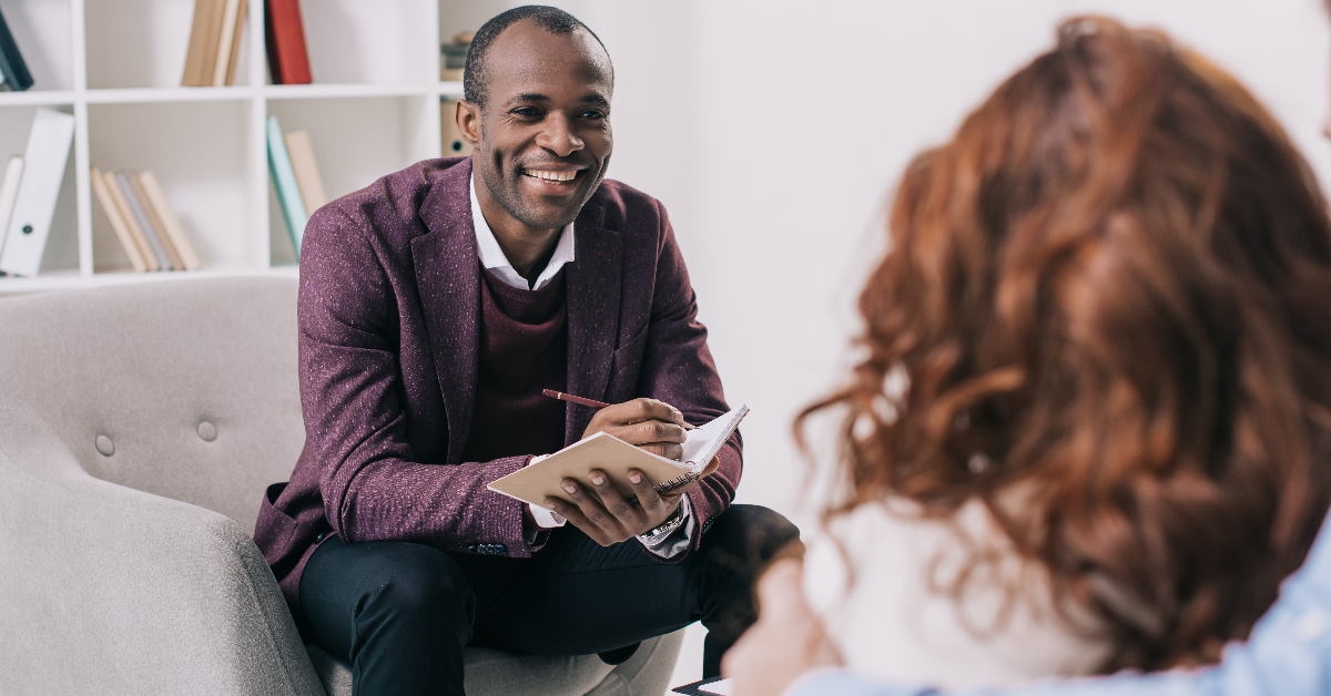 young couple getting counselling from african american psychiatrist in clinic