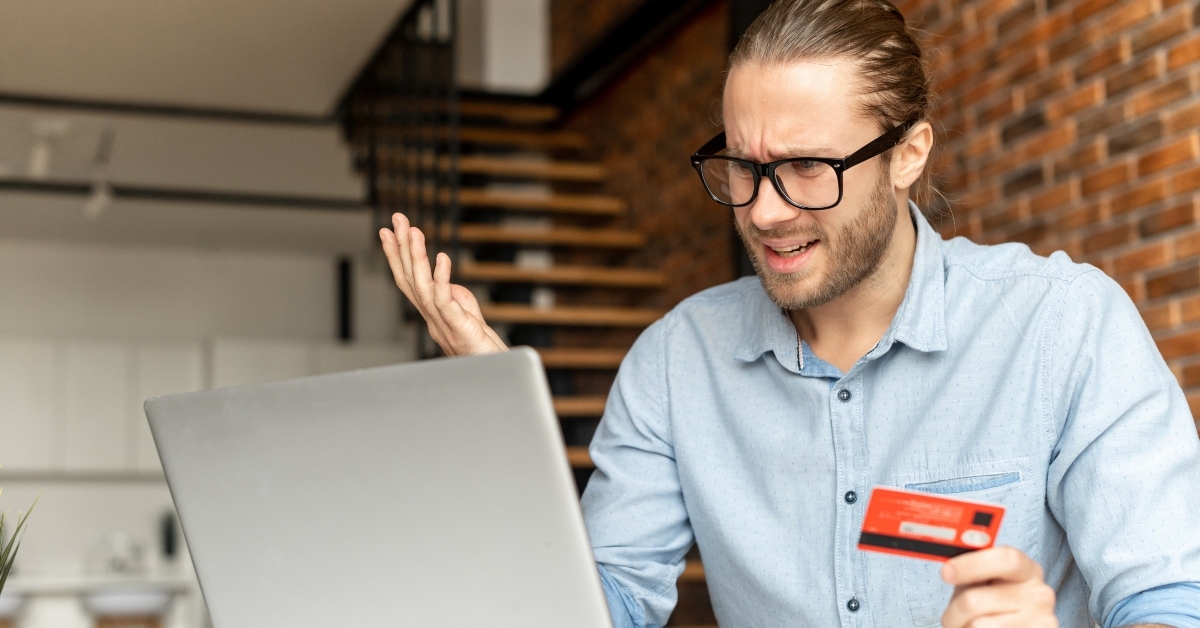 businessman faced with a problem while paying by credit card