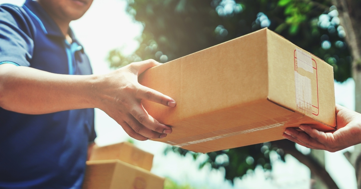 delivery man giving parcel box to customer